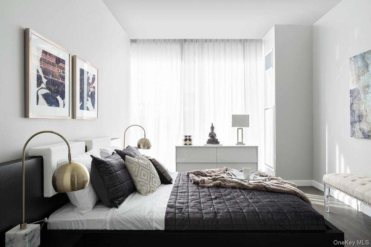 131-03 40 Road, Unit 11J Queens, NY 11354 - Photo 3 of 24 a bedroom with bed and window