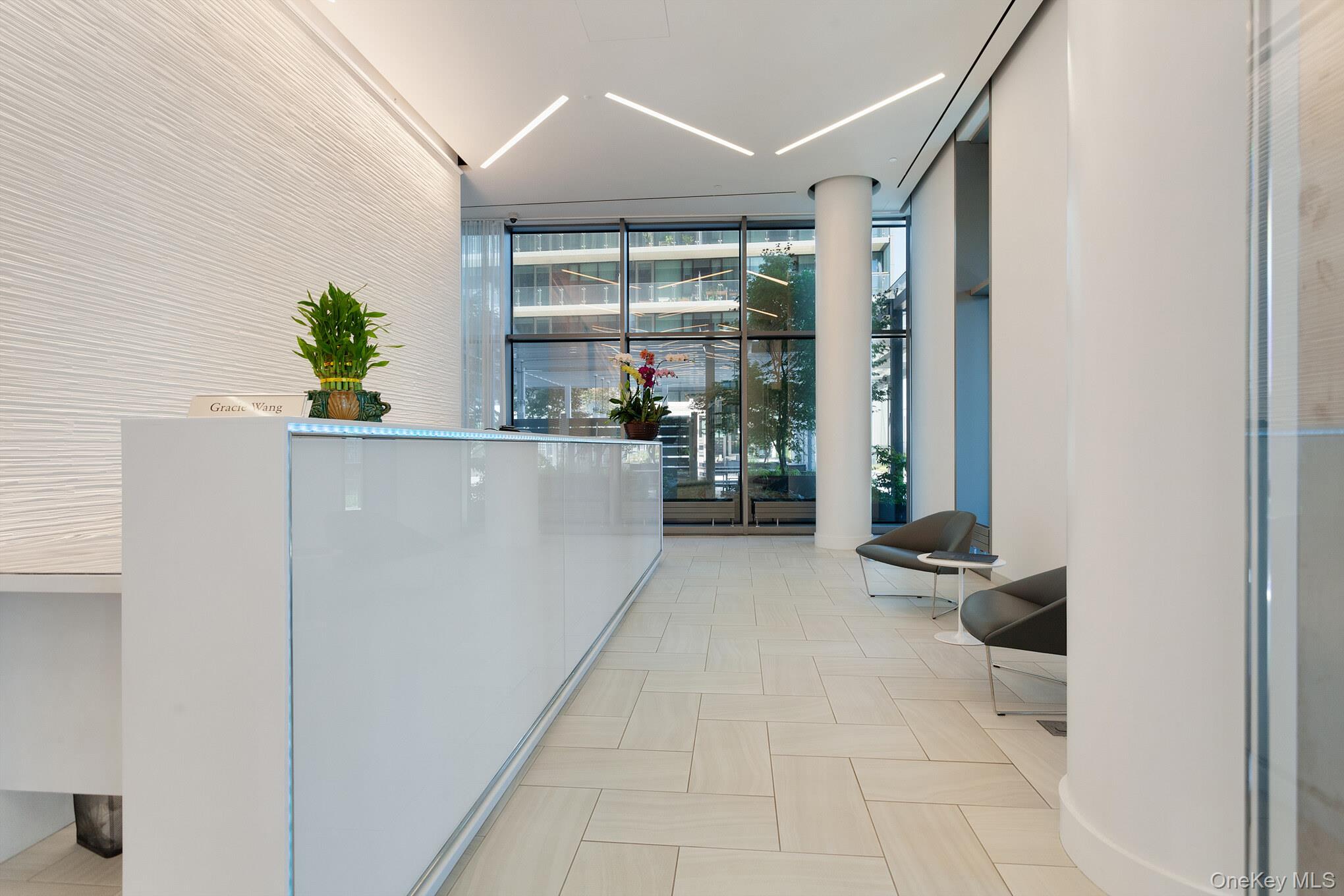 131-03 40 Road, Unit 11J Queens, NY 11354 - Photo 9 of 24 a living room with furniture and large windows