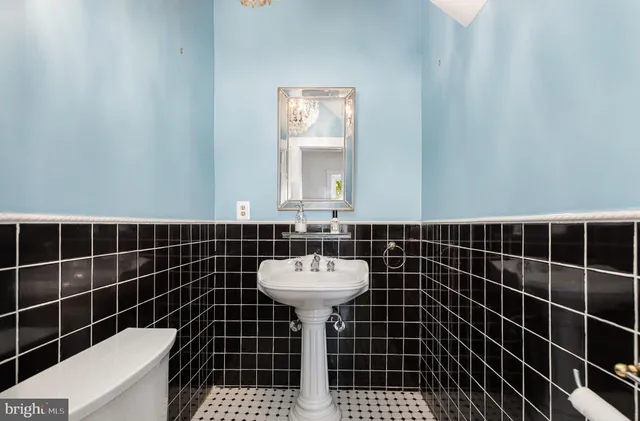 a bathroom with a sink toilet shower and a mirror