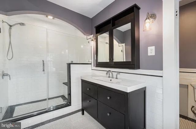 a bathroom with a double vanity sink mirror and double