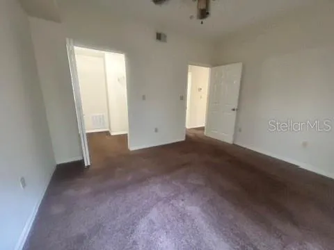 an empty room with windows and closet