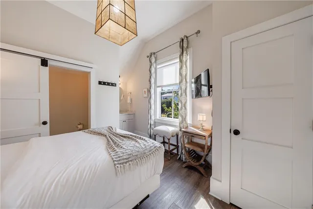 a bedroom with a bed and a chandelier