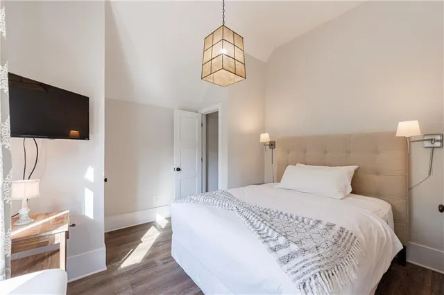 a bedroom with a bed and a flat screen tv