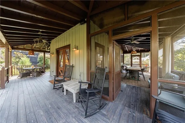 a view of a deck with table and chairs with wooden floor and fence