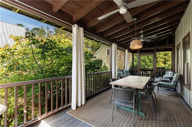 a view of a porch with furniture and wooden floor
