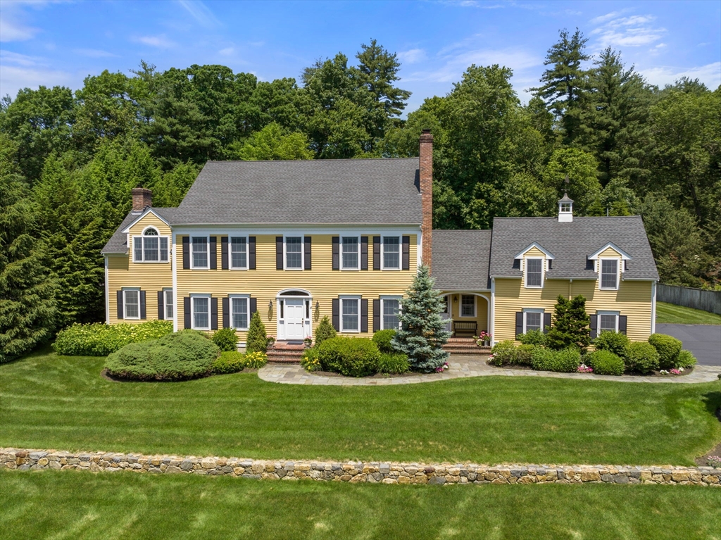 40 York Road Wayland, MA 01778 - Photo 1 of 37 a front view of a house with a yard table and chairs