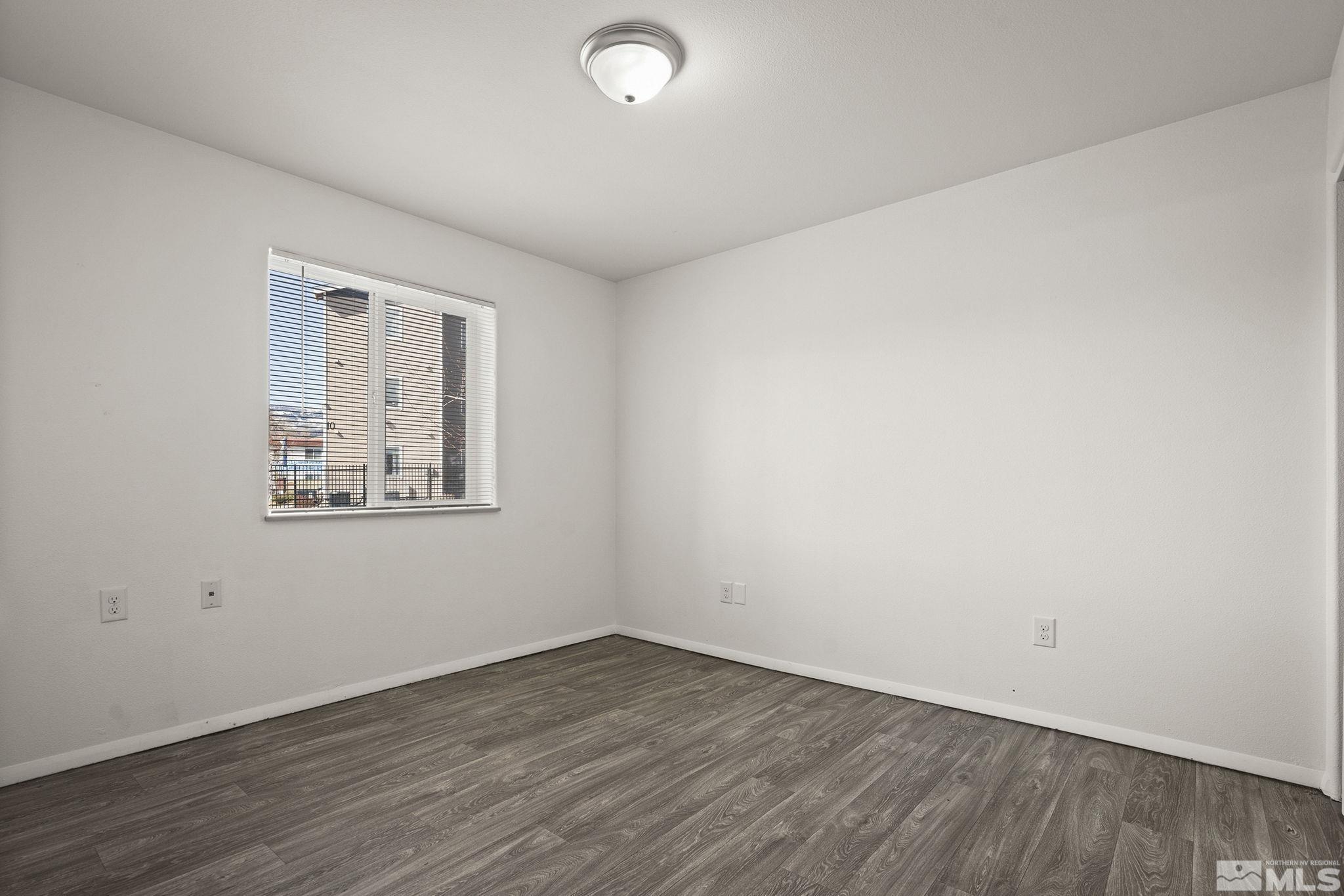 15 Gentry Way, Unit 12 Reno, NV 89502 - Photo 12 of 19 an empty room with wooden floor and windows