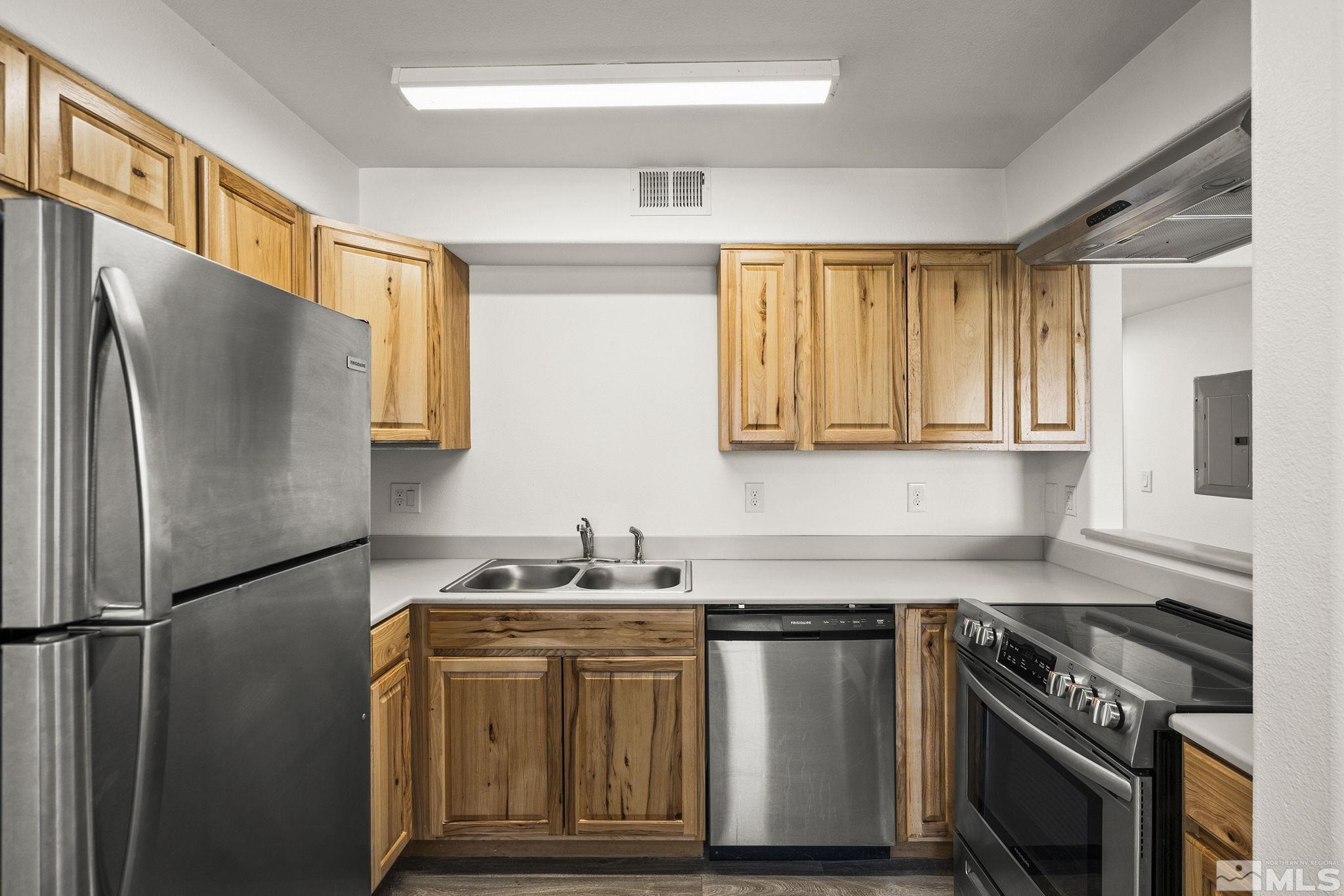 15 Gentry Way, Unit 12 Reno, NV 89502 - Photo 13 of 19 a kitchen with stainless steel appliances granite countertop a sink stove and refrigerator
