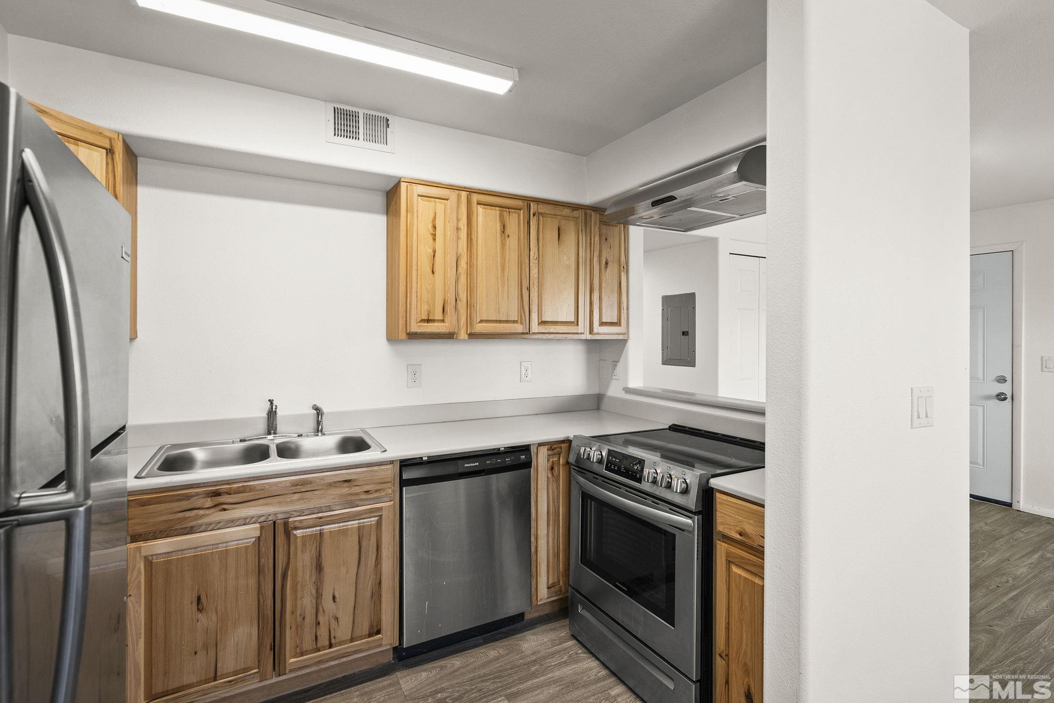 15 Gentry Way, Unit 12 Reno, NV 89502 - Photo 14 of 19 a kitchen with stainless steel appliances granite countertop a sink stove and refrigerator