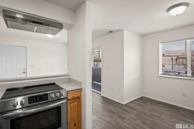 a kitchen with granite countertop a stove and a refrigerator