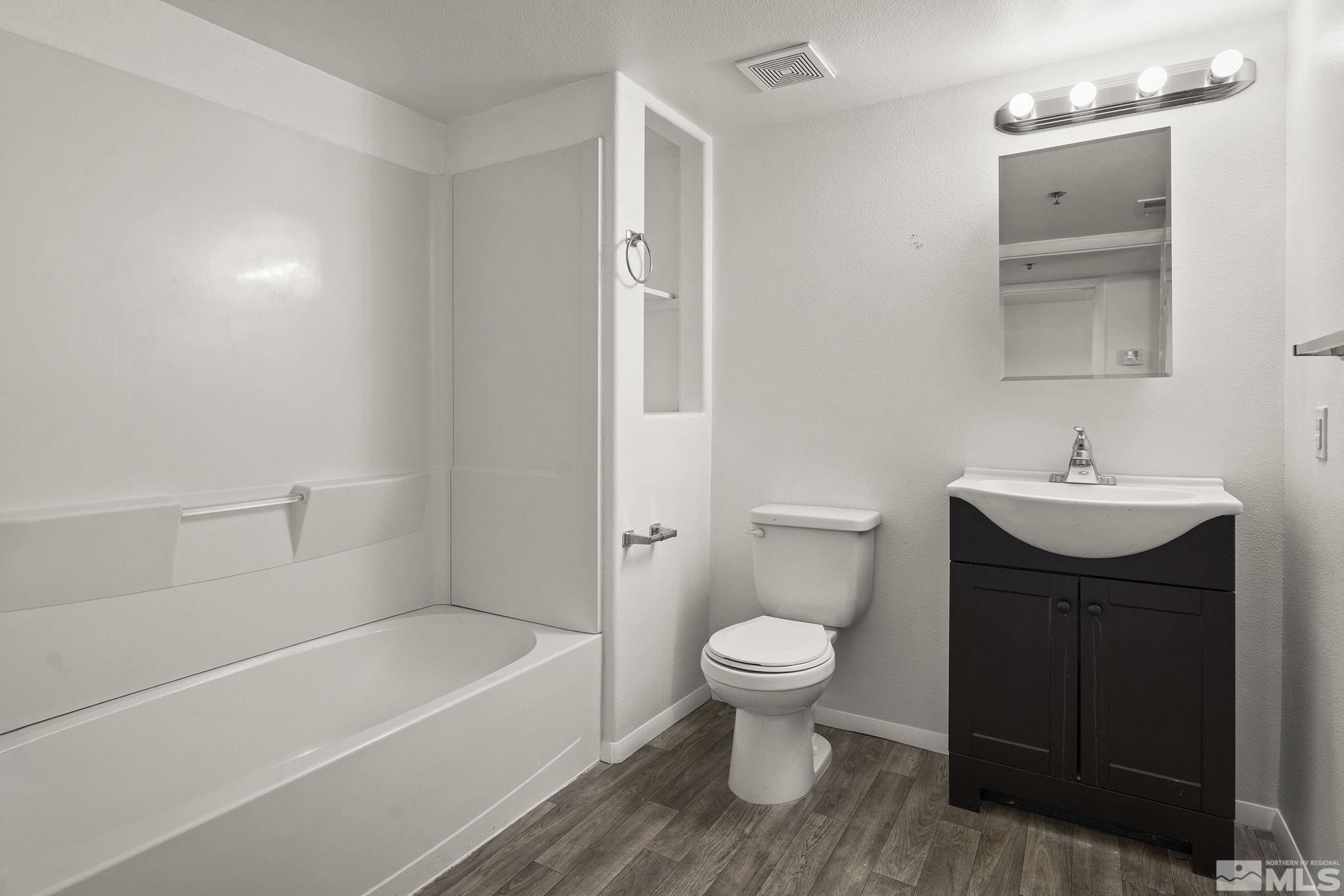 15 Gentry Way, Unit 12 Reno, NV 89502 - Photo 17 of 19 a bathroom with a sink toilet a bathtub and shower