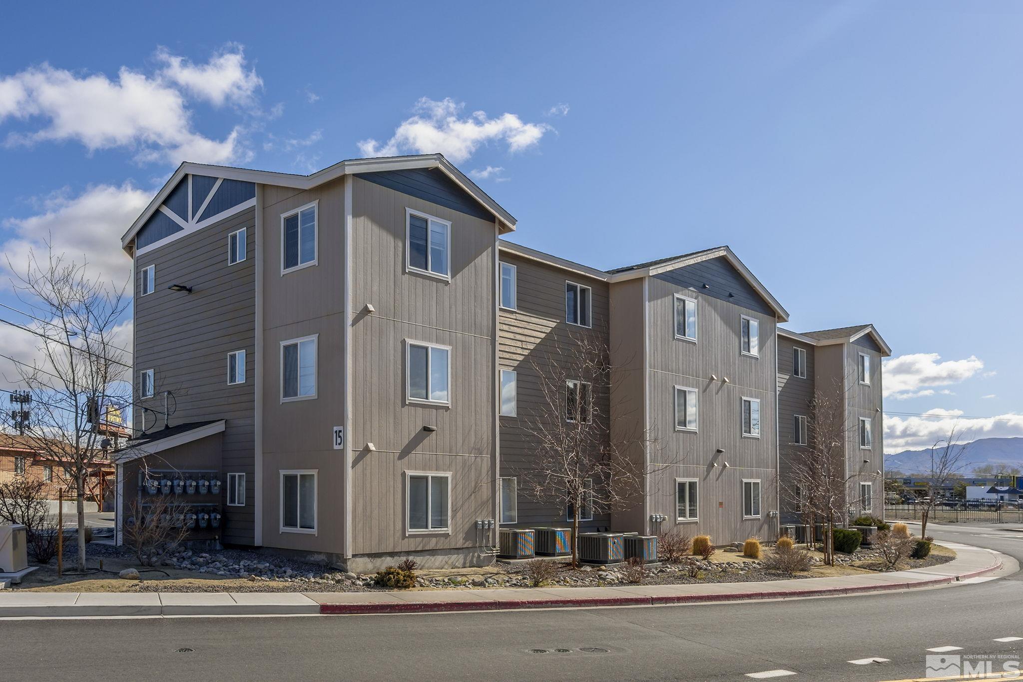 15 Gentry Way, Unit 12 Reno, NV 89502 - Photo 3 of 19 a front view of a building with a yard