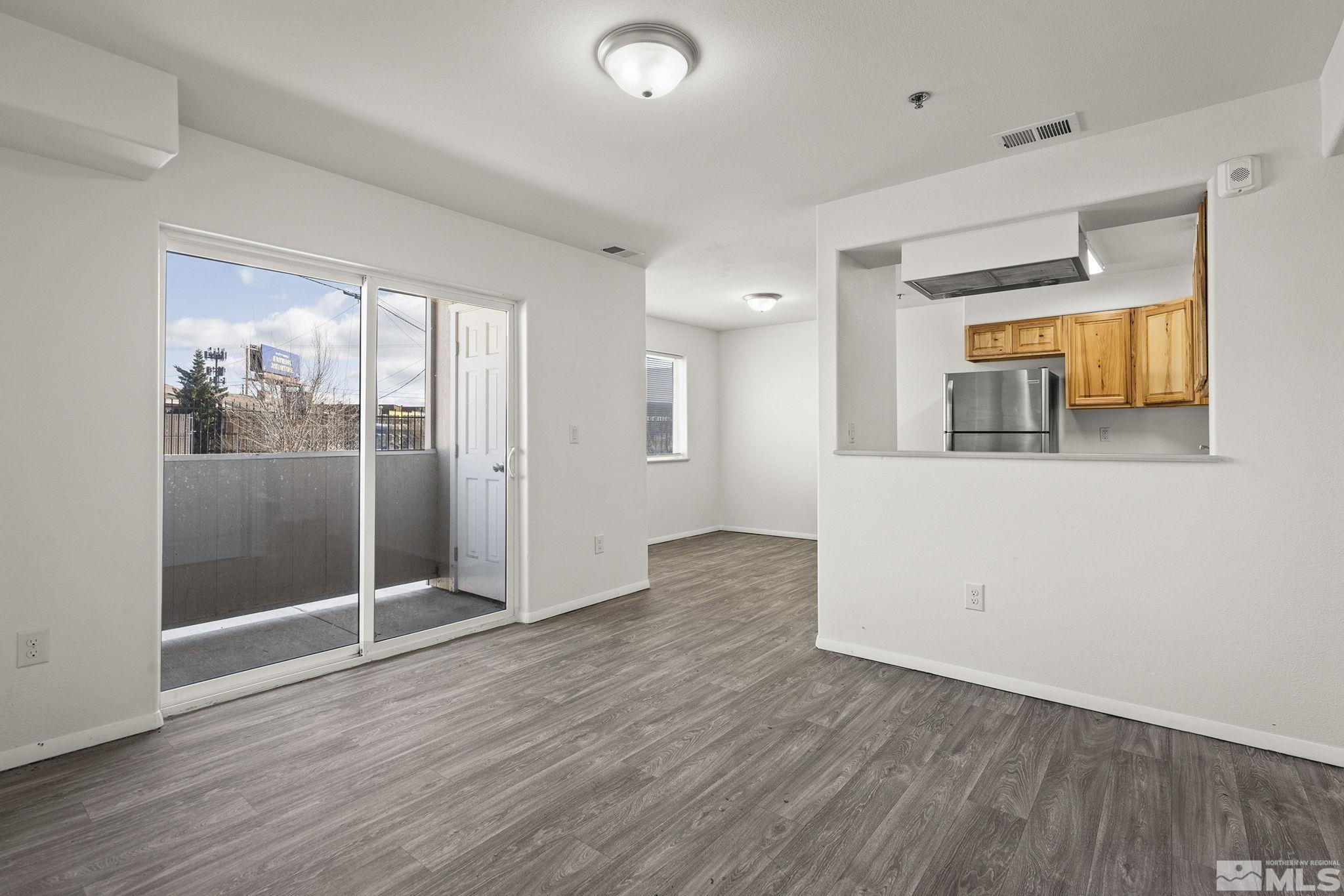 15 Gentry Way, Unit 12 Reno, NV 89502 - Photo 6 of 19 wooden floor in an empty room with a window