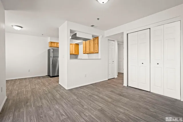 an empty room with wooden floor and a window