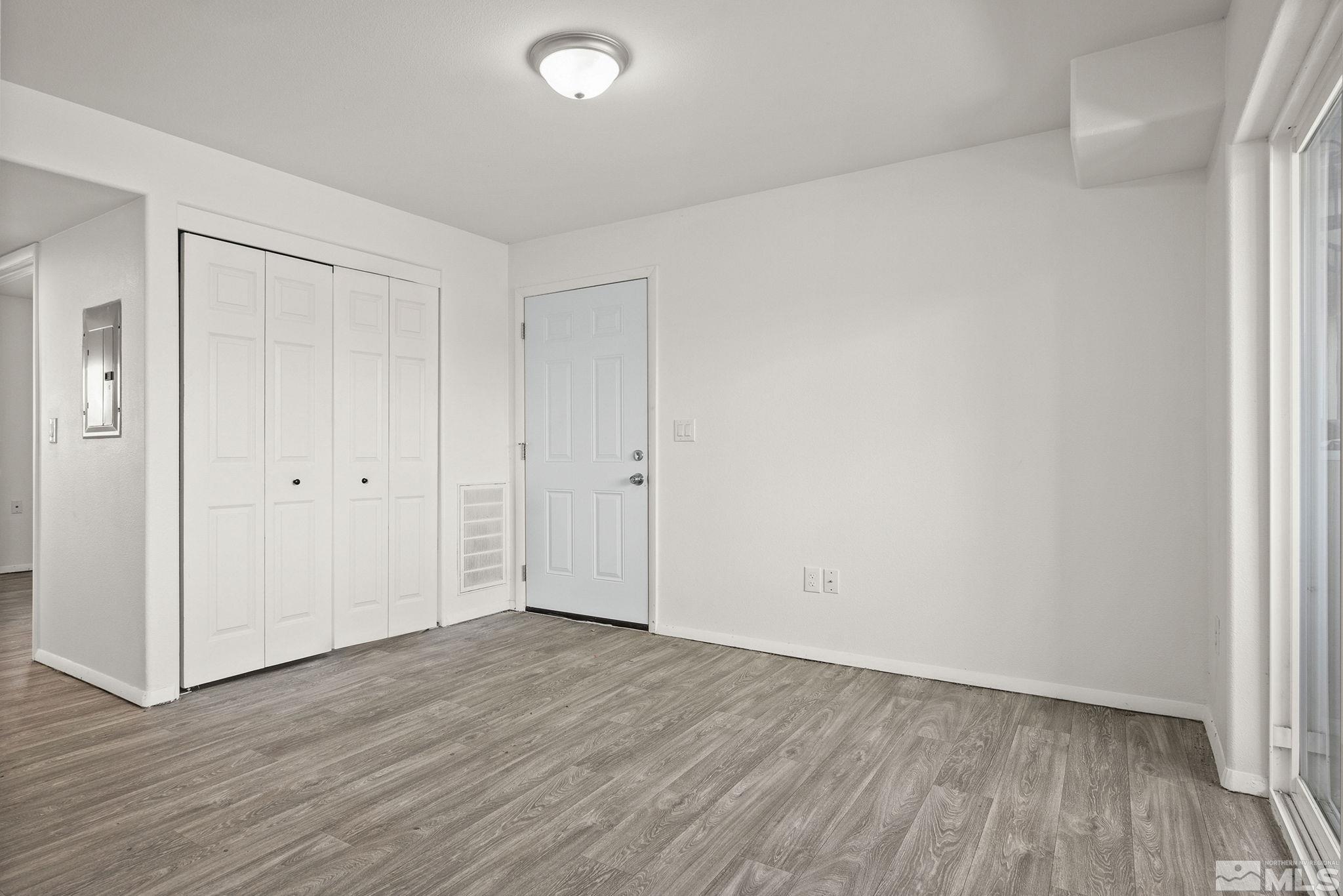 15 Gentry Way, Unit 12 Reno, NV 89502 - Photo 9 of 19 a view of an empty room with wooden floor