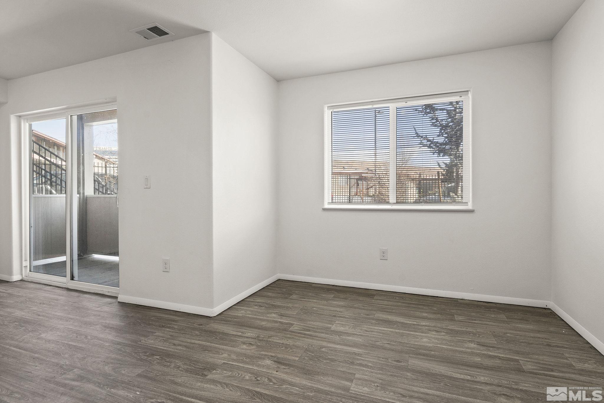15 Gentry Way, Unit 12 Reno, NV 89502 - Photo 10 of 19 an empty room with wooden floor and windows