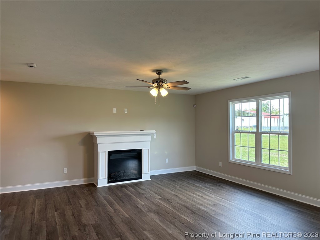 2526 Sand Hill Road Fayetteville, NC 28306 - Photo 11 of 40 a view of an empty room with window and wooden floor
