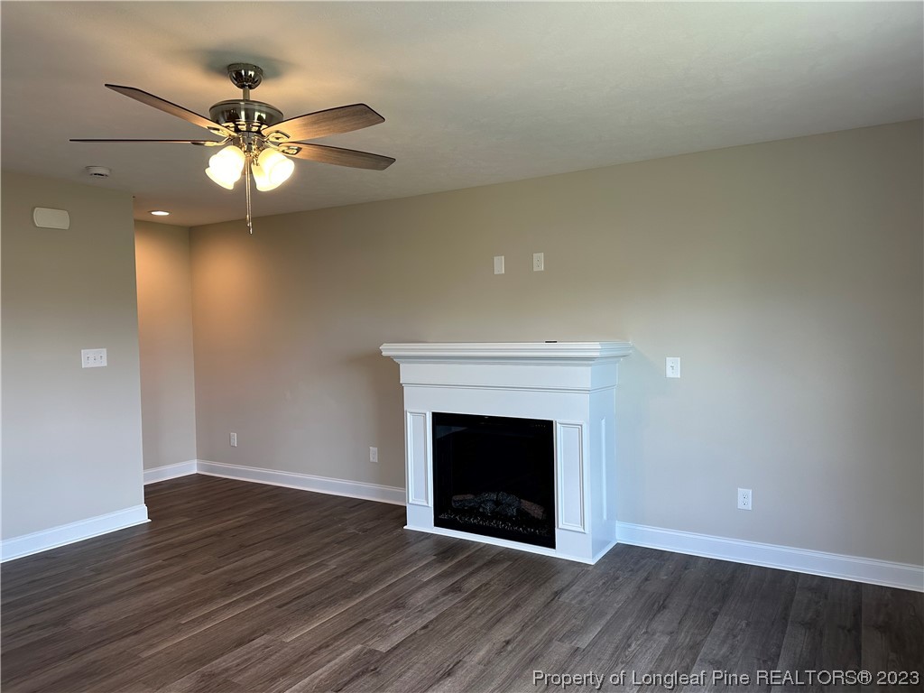 2526 Sand Hill Road Fayetteville, NC 28306 - Photo 12 of 40 a view of an empty room with wooden floor and a fireplace