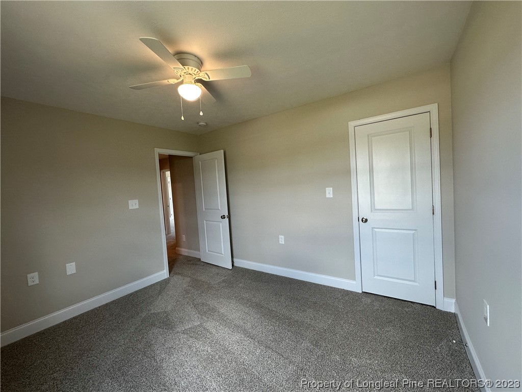 2526 Sand Hill Road Fayetteville, NC 28306 - Photo 17 of 40 a view of an empty room with a ceiling fan and window