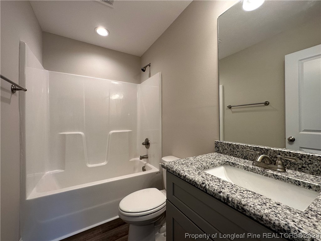 2526 Sand Hill Road Fayetteville, NC 28306 - Photo 19 of 40 a bathroom with a granite countertop sink a toilet and shower