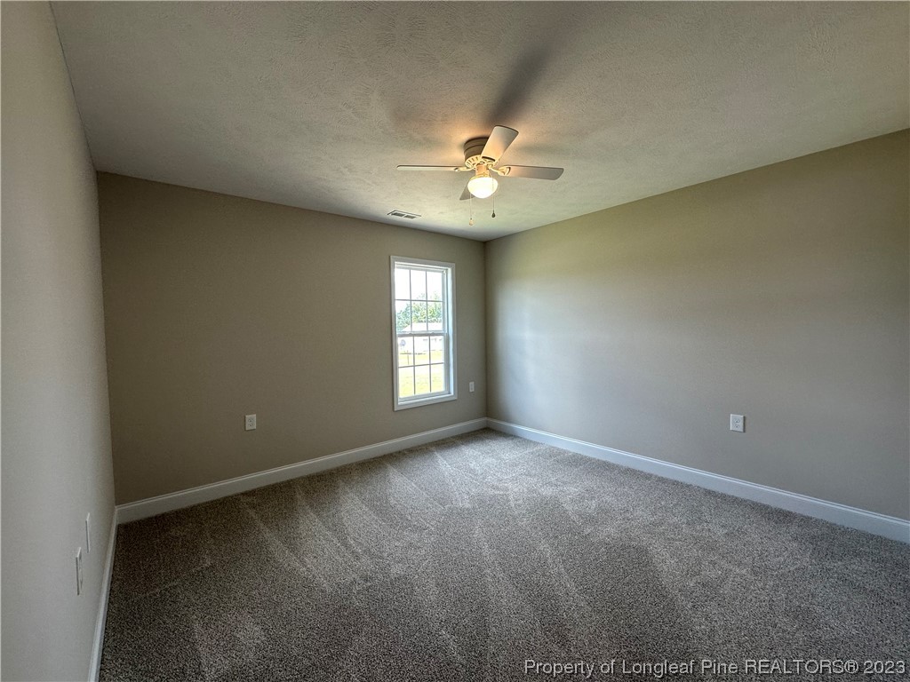 2526 Sand Hill Road Fayetteville, NC 28306 - Photo 20 of 40 an empty room with a window and a ceiling fan