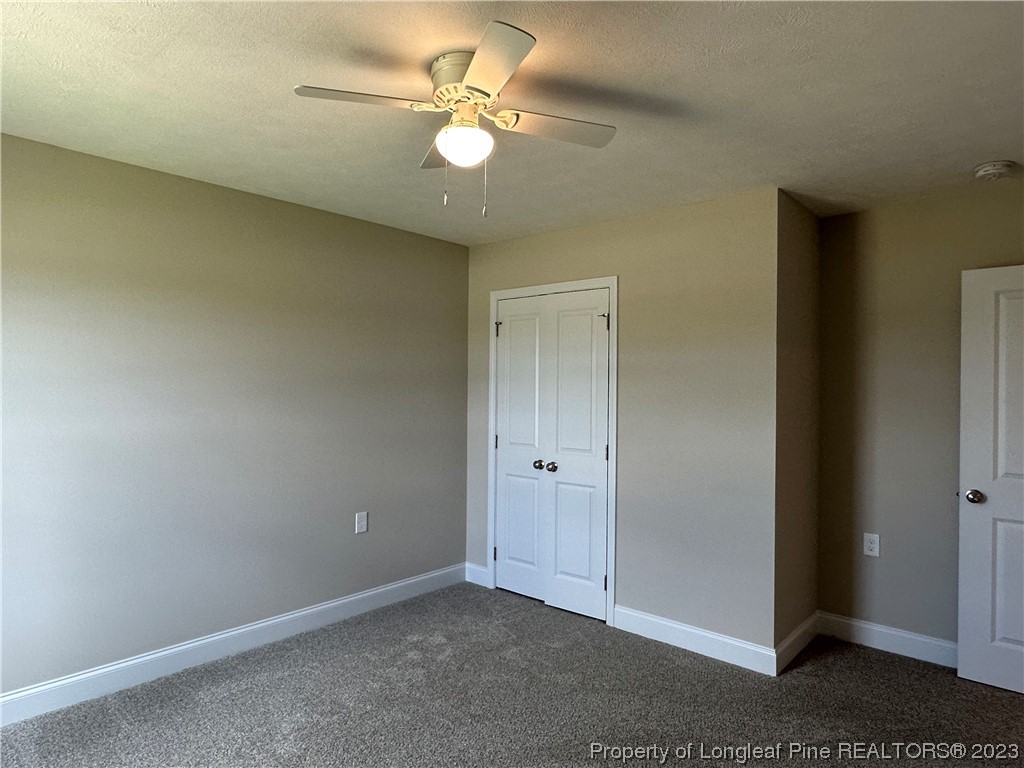 2526 Sand Hill Road Fayetteville, NC 28306 - Photo 22 of 40 an empty room with a ceiling fan