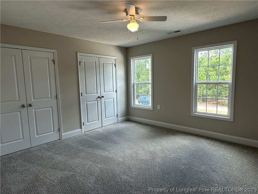 2526 Sand Hill Road Fayetteville, NC 28306 - Photo 23 of 40 an empty room with windows and fan