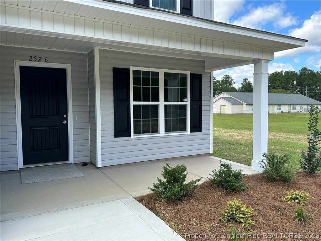 2526 Sand Hill Road Fayetteville, NC 28306 - Photo 3 of 40 a view of a house with a large window and flower plants