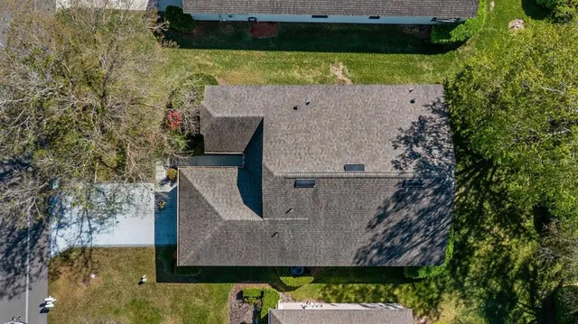 an aerial view of a house with a yard basket ball court and outdoor seating