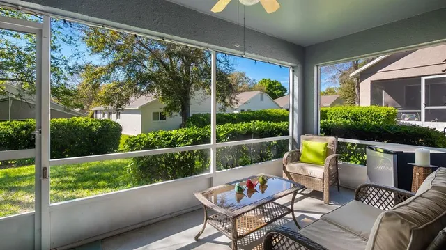 a view of a chairs and table in patio with a small yard