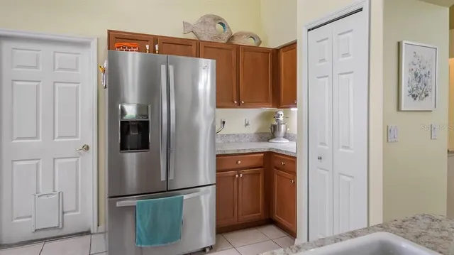 a kitchen with stainless steel appliances granite countertop a refrigerator and a sink