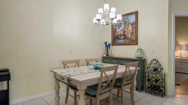 a view of a dining room with furniture and chandelier