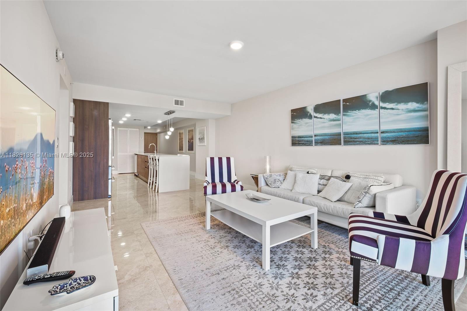 9261 East Bay Harbor Drive, Unit 404 Bay Harbor Islands, FL 33154 - Photo 23 of 49 a living room with furniture and a flat screen tv