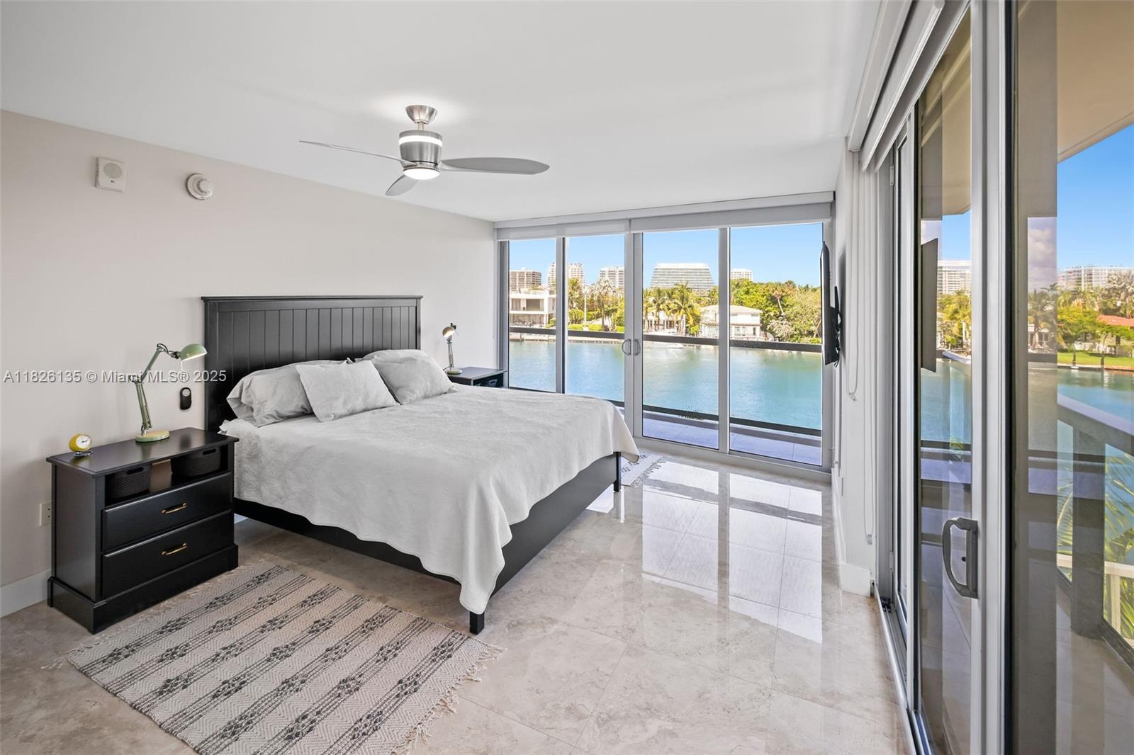 9261 East Bay Harbor Drive, Unit 404 Bay Harbor Islands, FL 33154 - Photo 26 of 49 a bedroom with a bed and a large window