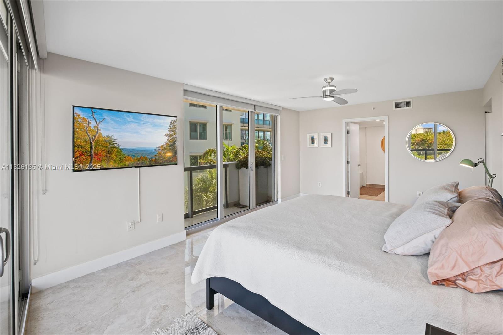 9261 East Bay Harbor Drive, Unit 404 Bay Harbor Islands, FL 33154 - Photo 28 of 49 a bedroom with a bed and a large window