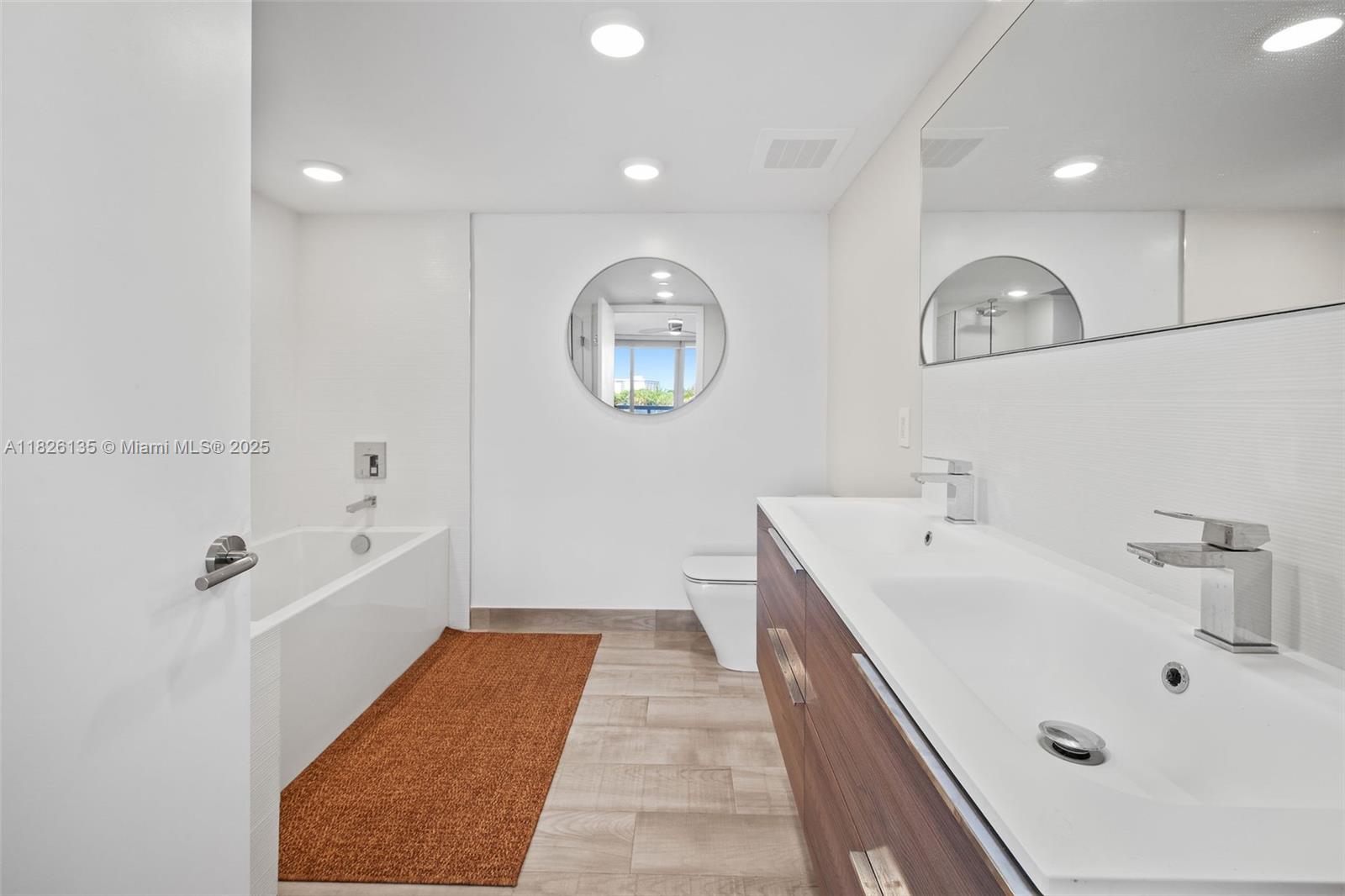 9261 East Bay Harbor Drive, Unit 404 Bay Harbor Islands, FL 33154 - Photo 29 of 49 a bathroom with a double vanity sink and a mirror