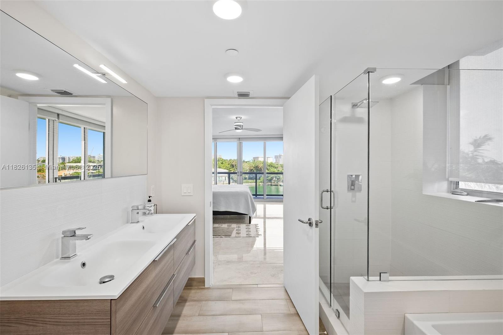 9261 East Bay Harbor Drive, Unit 404 Bay Harbor Islands, FL 33154 - Photo 30 of 49 a bathroom with a double vanity sink and mirror