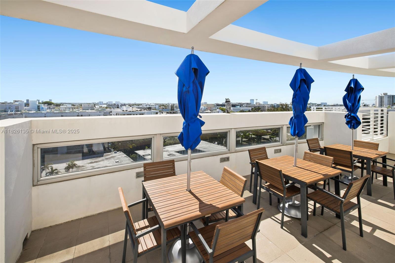 9261 East Bay Harbor Drive, Unit 404 Bay Harbor Islands, FL 33154 - Photo 40 of 49 a dining room with furniture and a floor to ceiling window