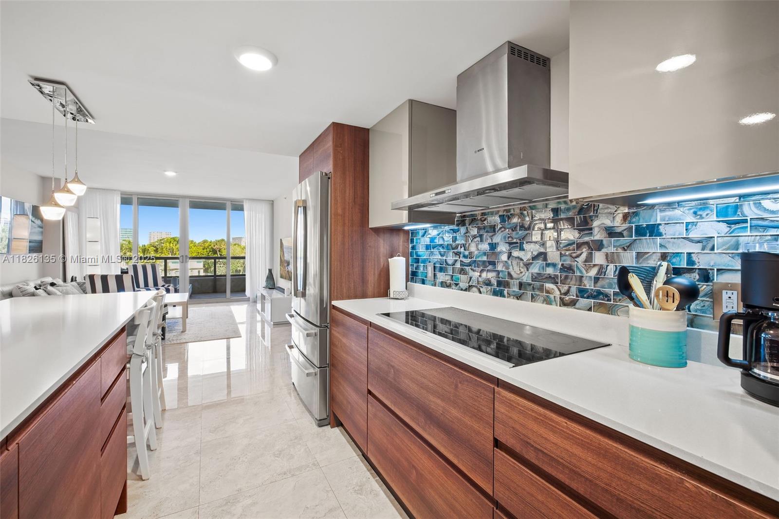 9261 East Bay Harbor Drive, Unit 404 Bay Harbor Islands, FL 33154 - Photo 5 of 49 a kitchen with stainless steel appliances granite countertop a stove a sink and a refrigerator