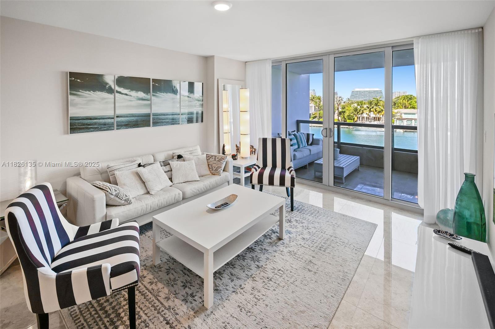 9261 East Bay Harbor Drive, Unit 404 Bay Harbor Islands, FL 33154 - Photo 9 of 49 a living room with a couch and a table