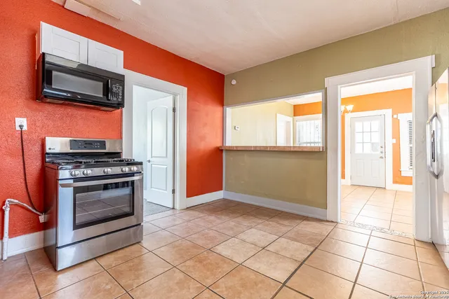 a view of kitchen with a stove cabinets and a kitchen counter top space