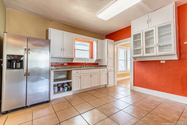 a kitchen with stainless steel appliances a refrigerator and a stove top oven