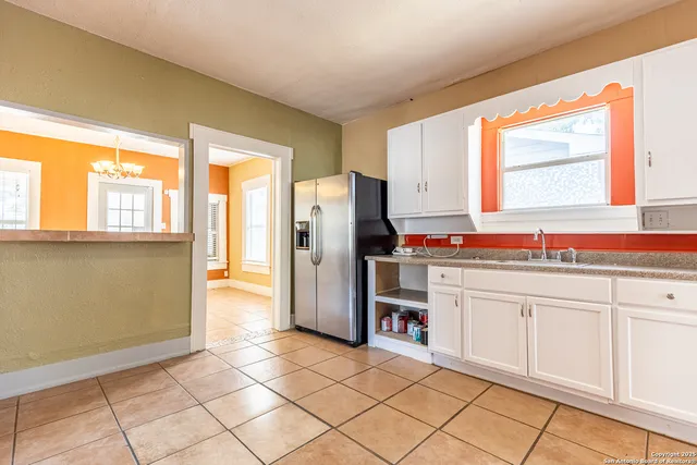 a kitchen with granite countertop a refrigerator and a sink