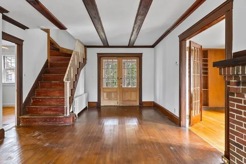 a view of an entryway with wooden floor and door