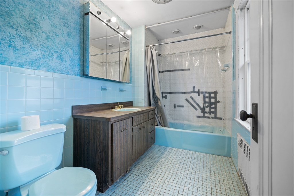 69 Horace Road Belmont, MA 02478 - Photo 17 of 27 a bathroom with a sink a toilet and bathtub