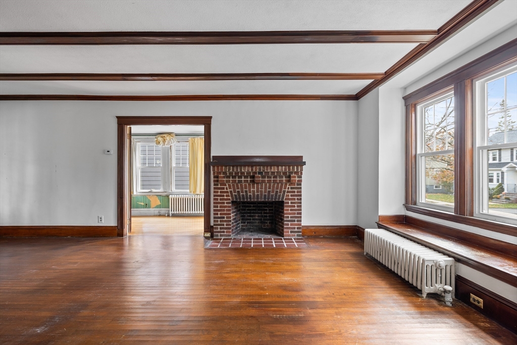 69 Horace Road Belmont, MA 02478 - Photo 6 of 27 a living room with wooden floor and a fireplace