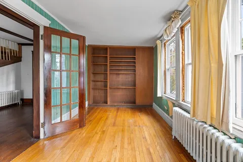 a view of a room with wooden floor and windows