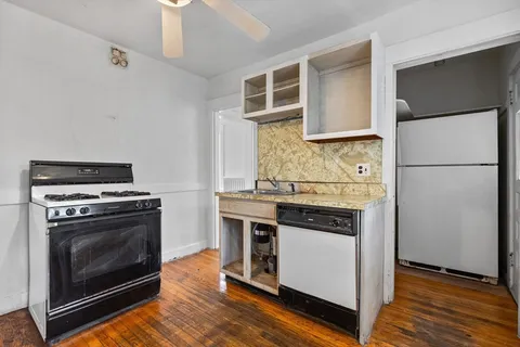 a kitchen with a stove and a refrigerator