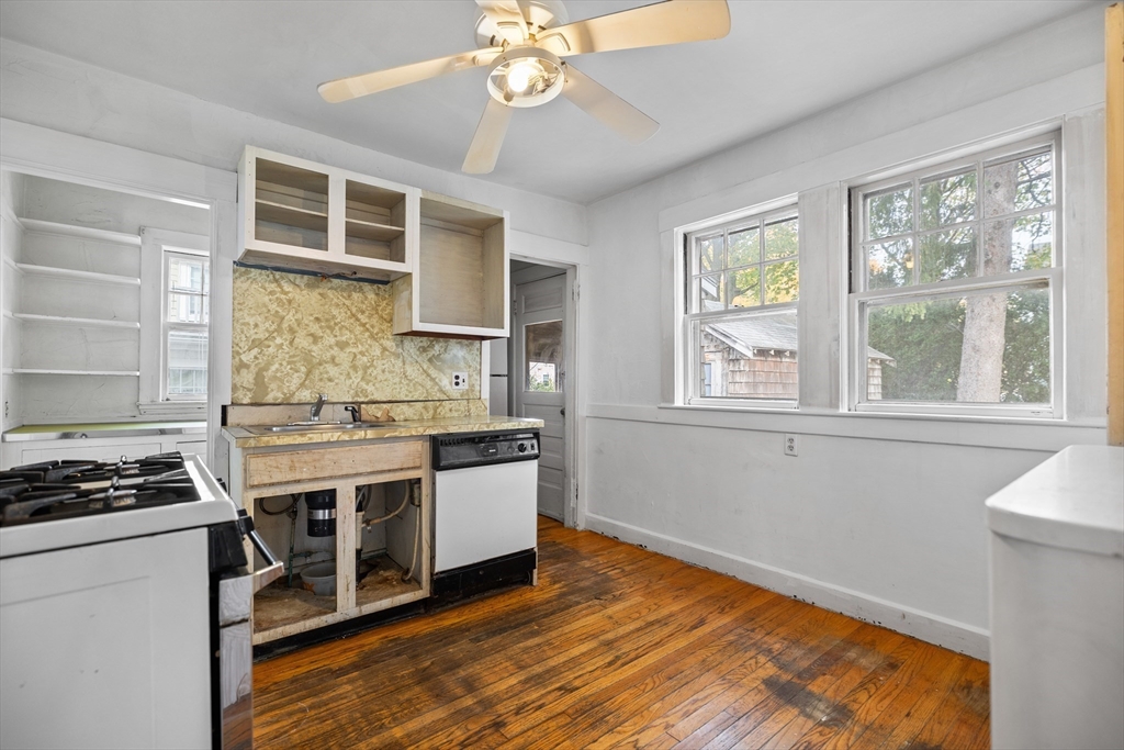 69 Horace Road Belmont, MA 02478 - Photo 10 of 27 a kitchen with stainless steel appliances granite countertop a stove and a white cabinets