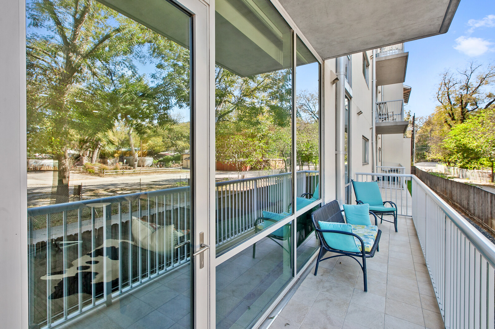 1600 Barton Springs Road, Unit 5110 Austin, TX 78704 - Photo 22 of 31 An inviting balcony offers peaceful outdoor lounging and verdant views.